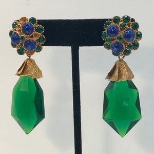 Vintage clip earrings consisting of a  green faceted drop with a flaw read more